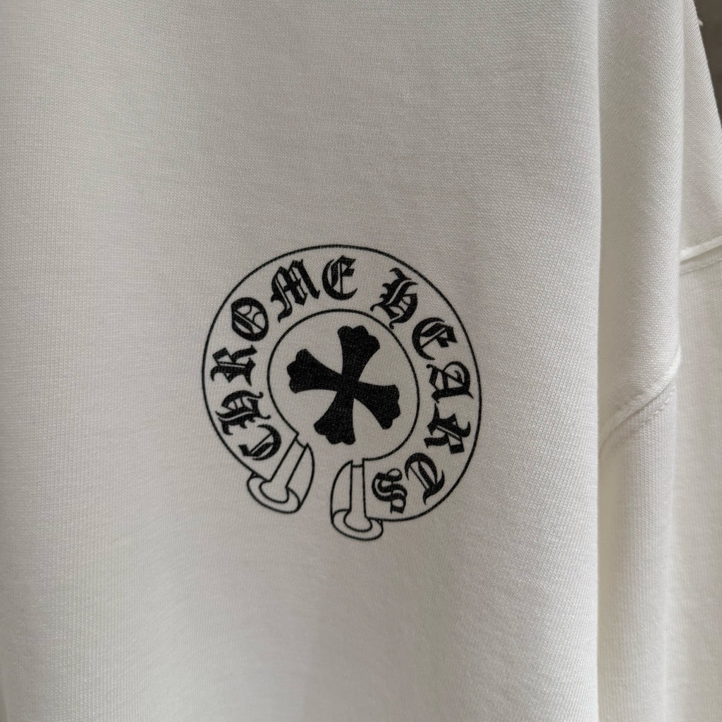 White long-sleeve shirt, close-up of circular chest emblem patch