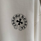 White long-sleeve shirt, close-up of circular chest emblem patch