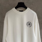 White long-sleeve shirt with circular chest emblem and crew neckline