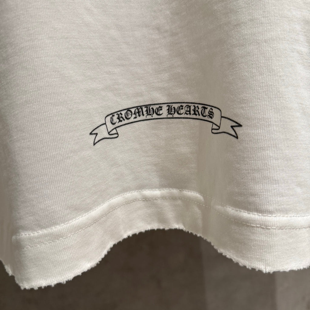 White long-sleeve shirt hem area with small printed ribbon text