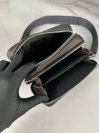 Fendi crossbody bag open view showing dark interior and two zip compartments with hardware.