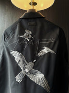 Amiri dark button-up shirt back yoke with white bird embroidery and script