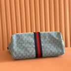Gucci tote bag with blue monogram and red/black center stripe, flat bottom