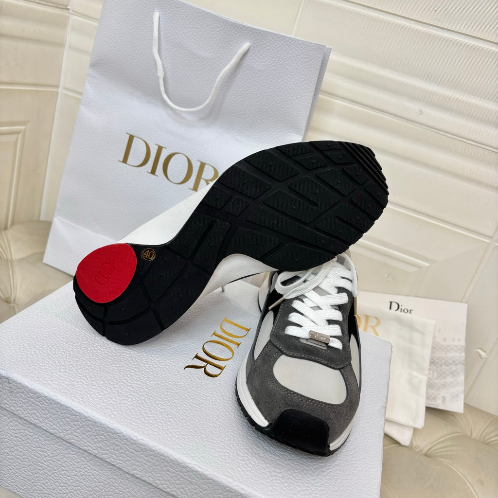 Unisex sneakers outsole view, black tread with gray/white uppers and red heel