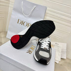 Unisex sneakers outsole view, black tread with gray/white uppers and red heel