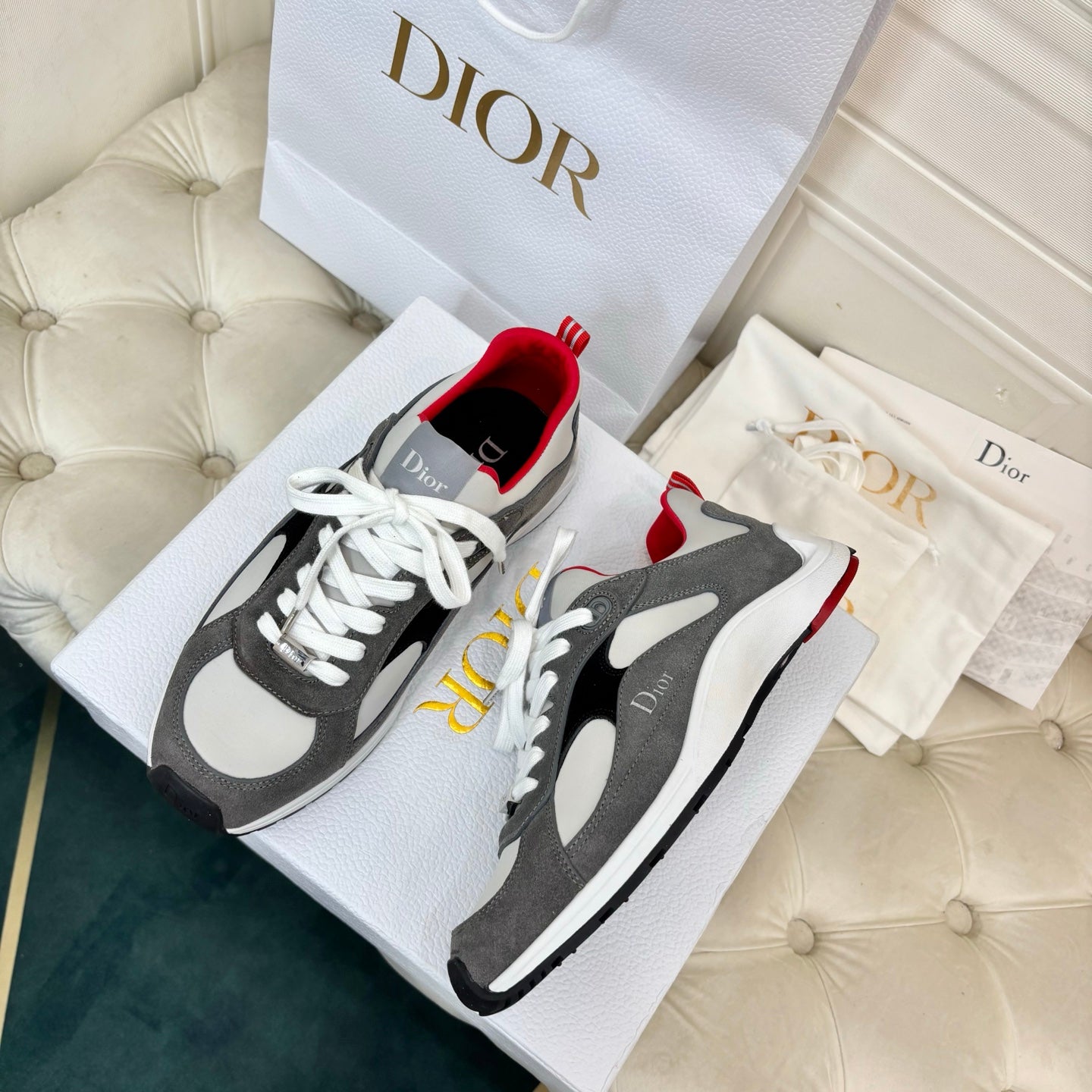 Unisex sneakers pair, gray and black with white panels, red accents, white laces