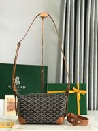 Monogram shoulder bag with tan leather trim, top handles, and crossbody strap