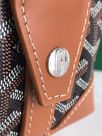 Brown leather corner patch with round silver emblem and stitched trim