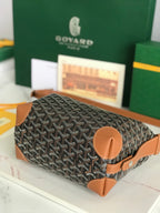 Monogram bag with tan rounded leather patch and short strap loop at the base