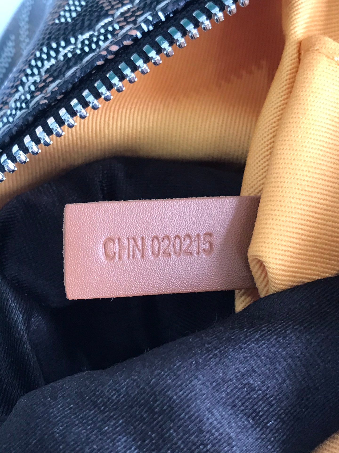 Cloth interior label with printed code text on dark fabric lining