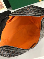 Monogram bag interior with orange lining and silver-tone zipper edge