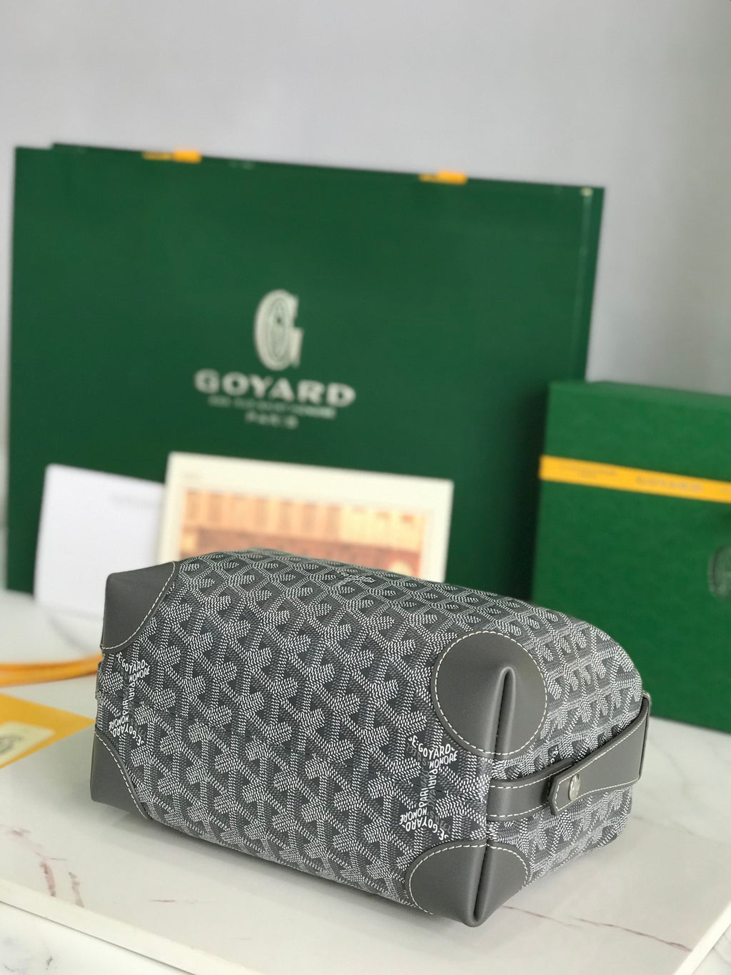 Goyard zip-around bag with dark gray monogram canvas and smooth dark leather trim