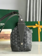 Goyard mini bag with dark gray monogram canvas, front snaps, and top handle