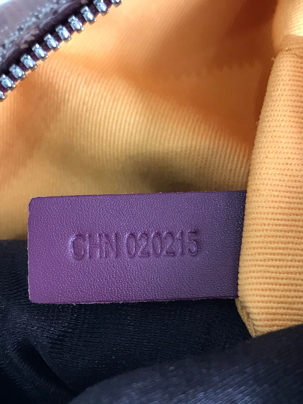 Leather size or code tag reading “CIN 022215” inside handbag