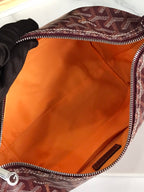 Open handbag interior with smooth orange lining and zippered edge