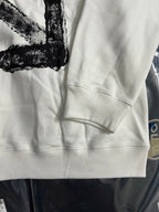 Off-white sweatshirt sleeve and front hem with kangaroo pocket seam