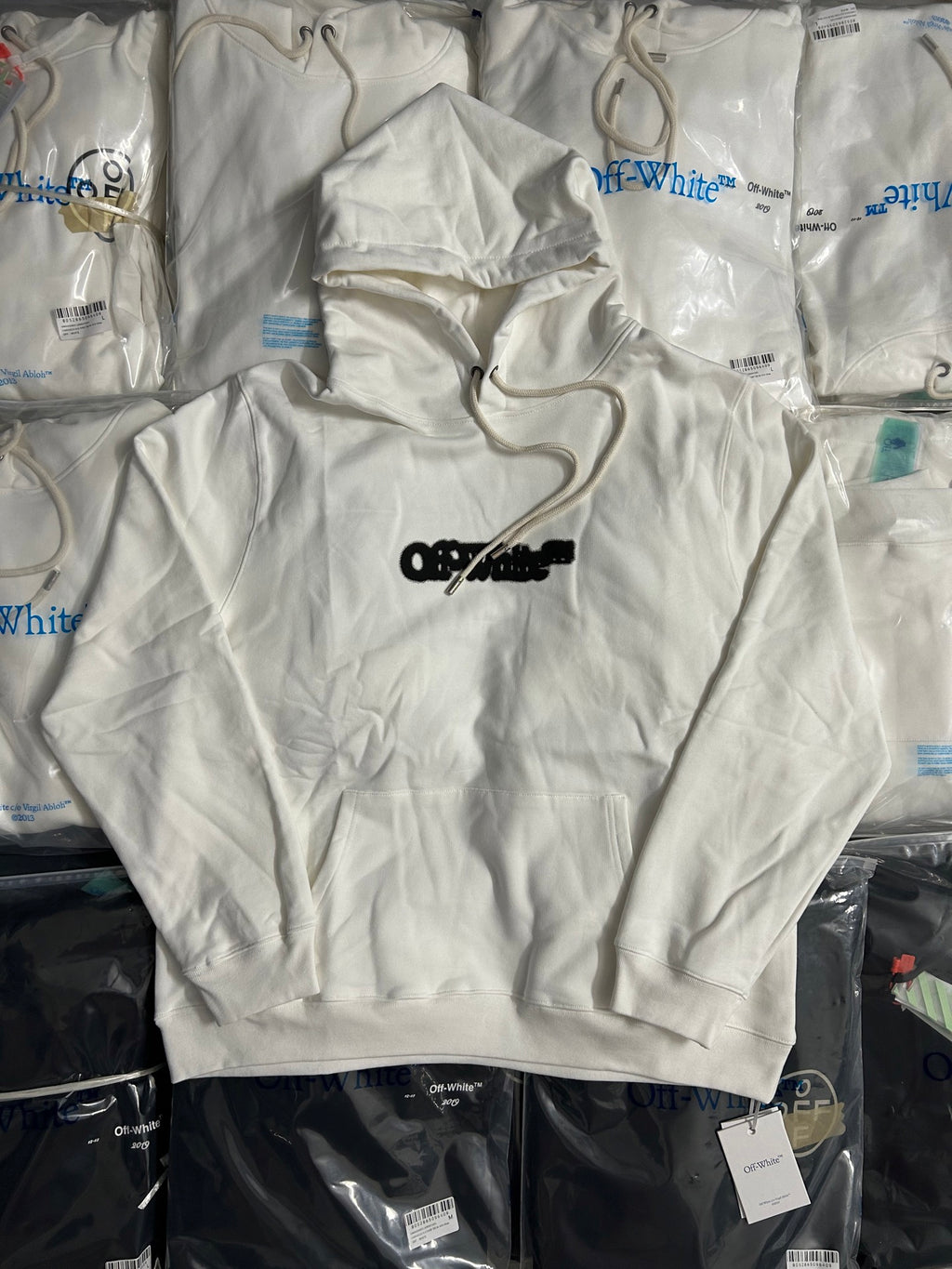White hoodie with hood and drawstring, black Off-White logo on chest