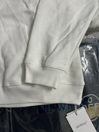 White hoodie sleeve cuff and front kangaroo pocket seam detail