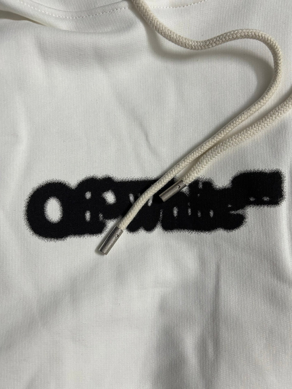 White hoodie neckline with drawstring and black Off-White logo print