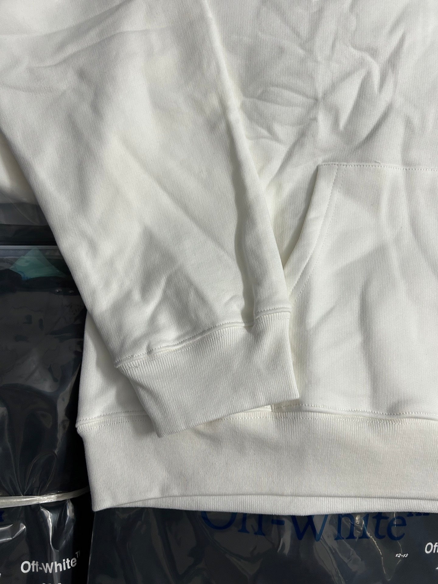 Off-white hoodie sweatshirt sleeve and kangaroo pocket area