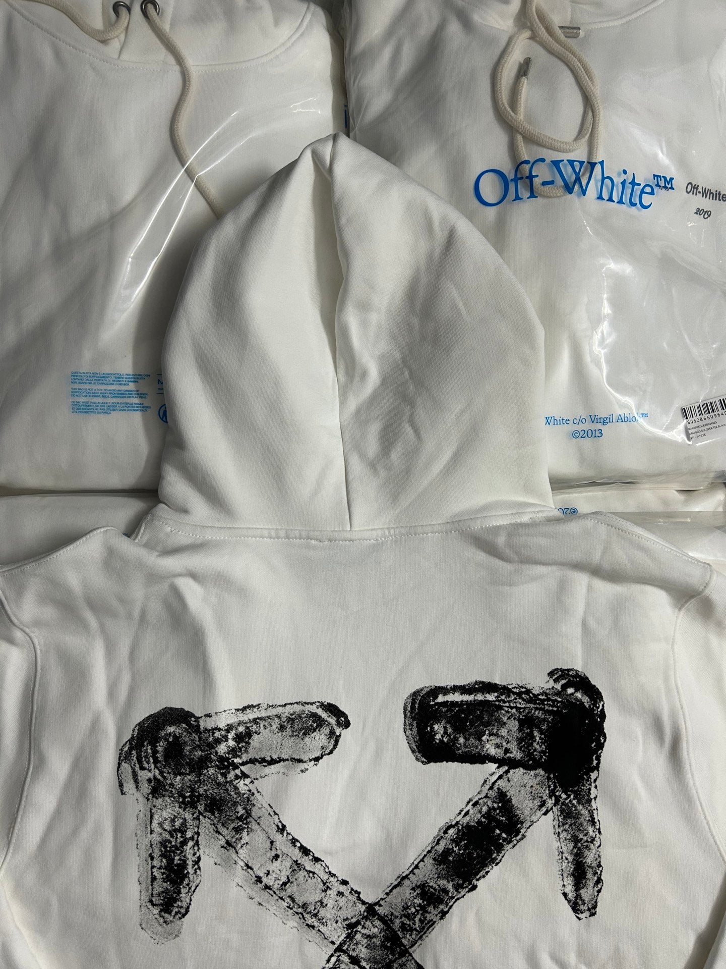 White hoodie with hood and large black X graphic print on front