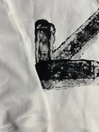 White hoodie close-up of black X graphic print