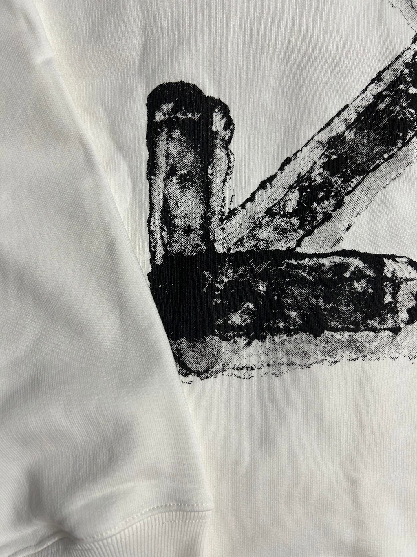 White hoodie close-up of black X graphic print