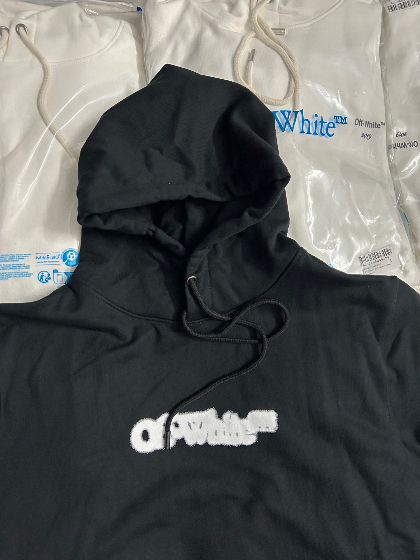 Black pullover hoodie with hood strings and small front logo print