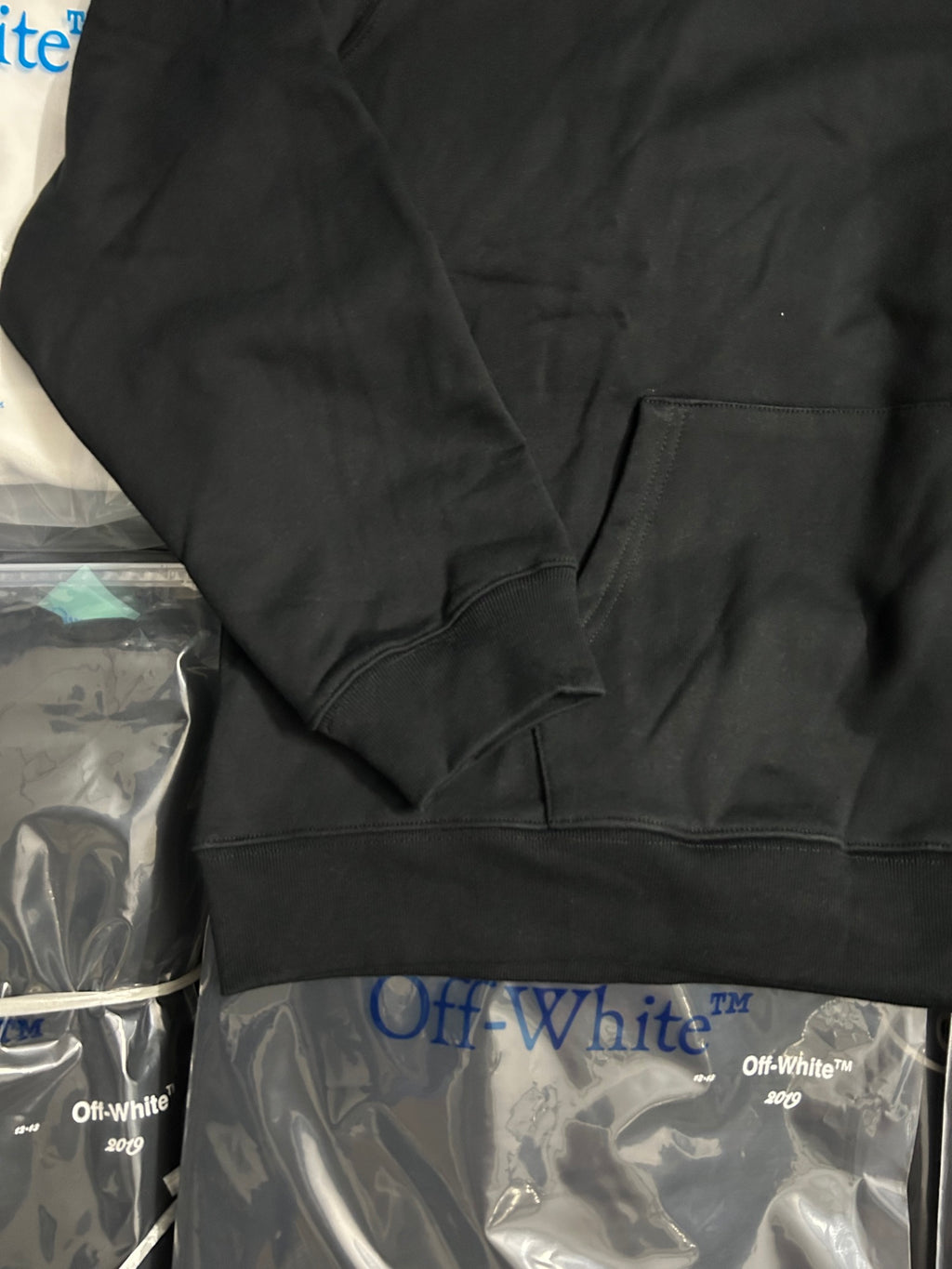 Black pullover hoodie with kangaroo pocket and ribbed cuffs