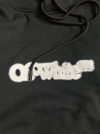 Black hoodie with white distressed logo print and drawstring cords