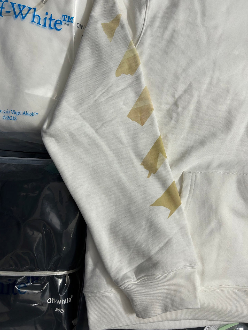 Off-White hooded sweatshirt sleeve detail with gold geometric patterns