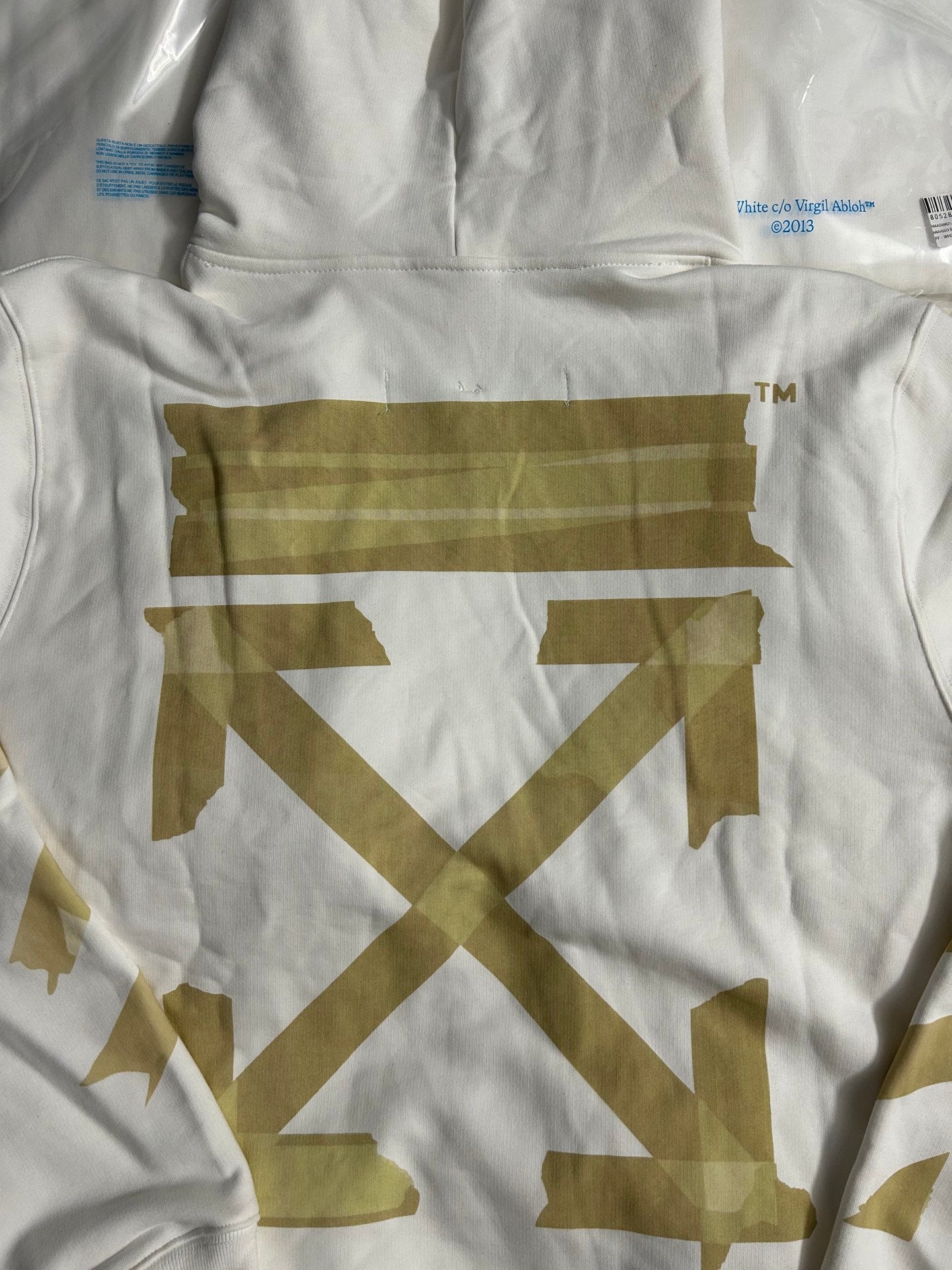 Off-White hooded sweatshirt chest emblem detail in gold on off-white fabric
