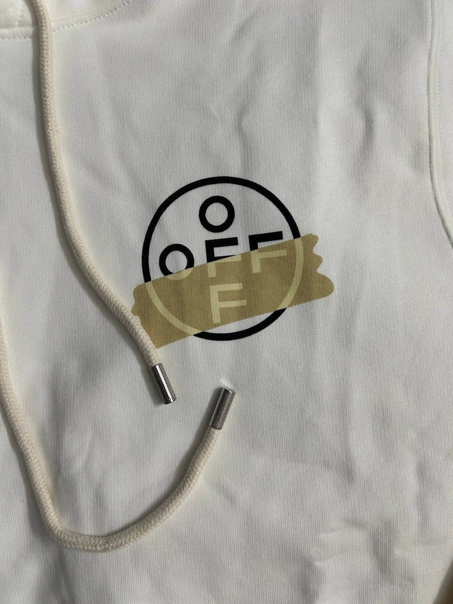 Off-White hooded sweatshirt neckline closeup with black O/F logo and metal aglets