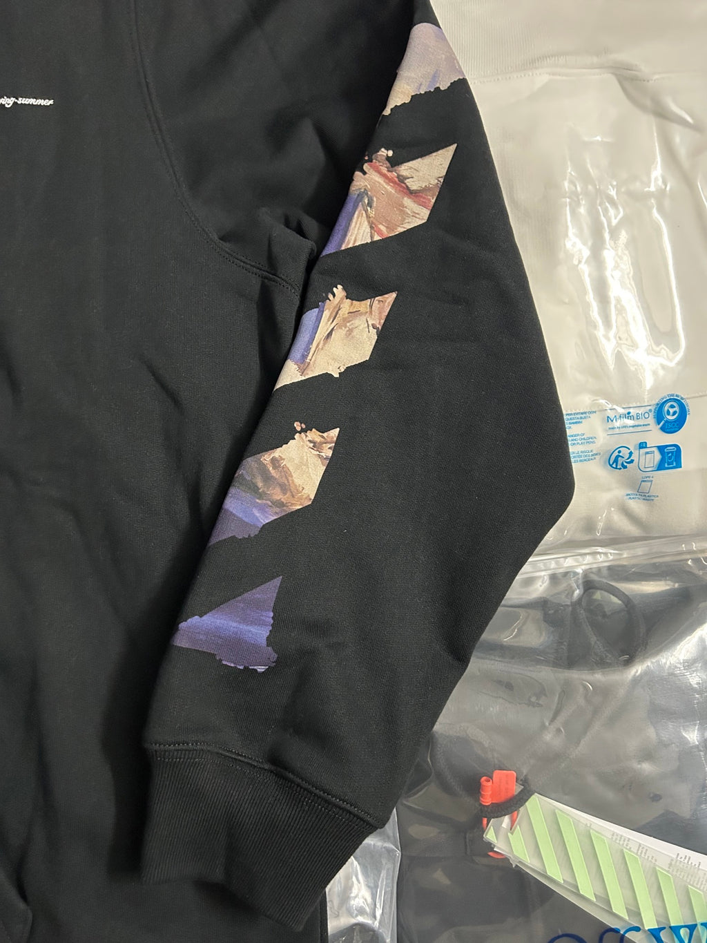 Off-White black hoodie sleeve with large multicolor graphic patch