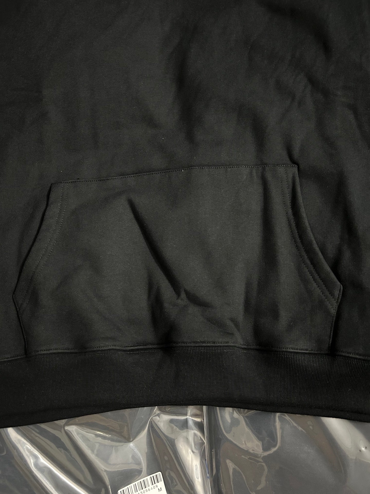 Off-White black hoodie hem area with kangaroo pocket seam