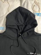 Black hoodie close view with hood, drawstrings, and front kangaroo pocket