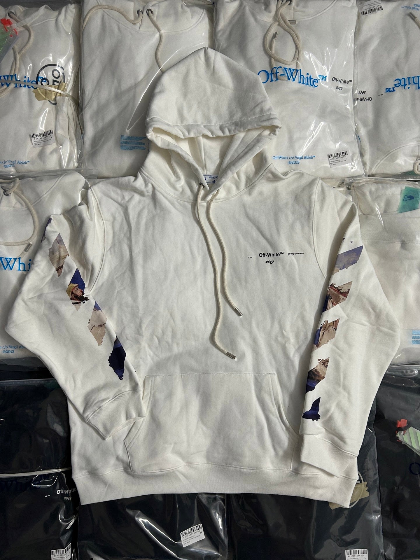 Off-White white hoodie with front kangaroo pocket and abstract blue graphic sleeves