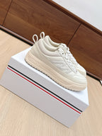 Moncler low-top sneakers, white lace-up with cushioned collar, chunky rubber sole