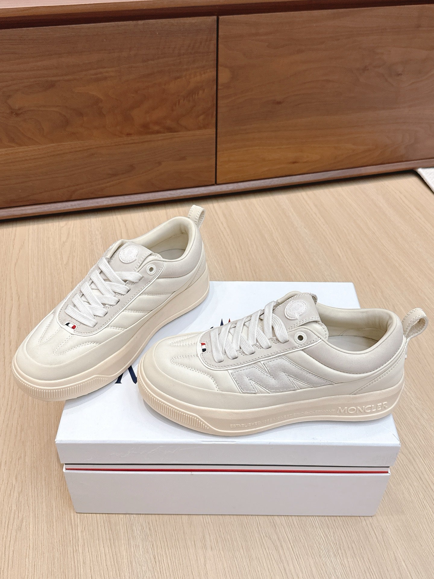 Moncler low-top sneakers, white lace-up design with stitched panels and gum rubber sole
