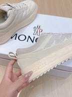 Moncler sneakers, white upper with stitched panels and branded rubber outsole