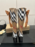 Burberry check ankle boots with tan leather, bow ties at the top, tall shaft view
