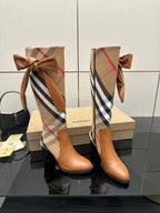 Pair of Burberry check ankle boots with tan leather bows at the shaft and block heels