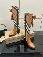 Burberry check ankle boots with tan leather, bow ties at the shaft, side profile