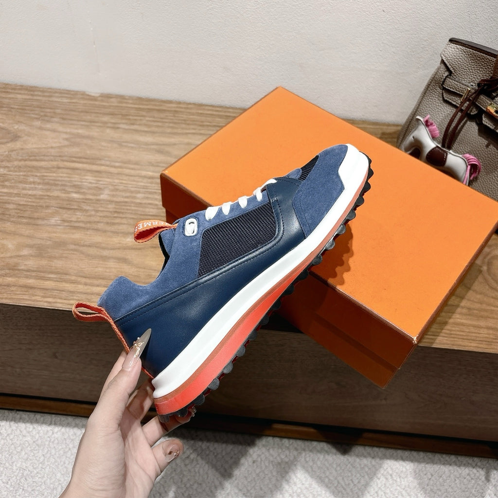 Hermes unisex sneakers side view, navy blue with white laces and orange trim