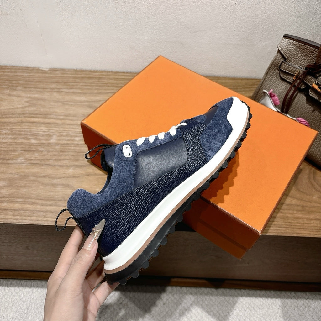 Dark blue unisex slip-on style sneakers with white midsole and sporty traction sole