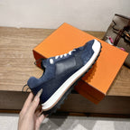 Dark blue unisex slip-on style sneakers with white midsole and sporty traction sole