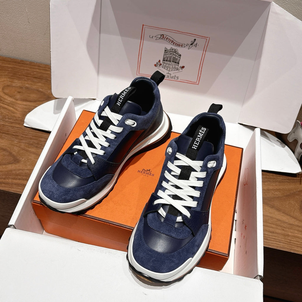 Unisex dark blue sneakers with white laces in open gift box, showing side profiles
