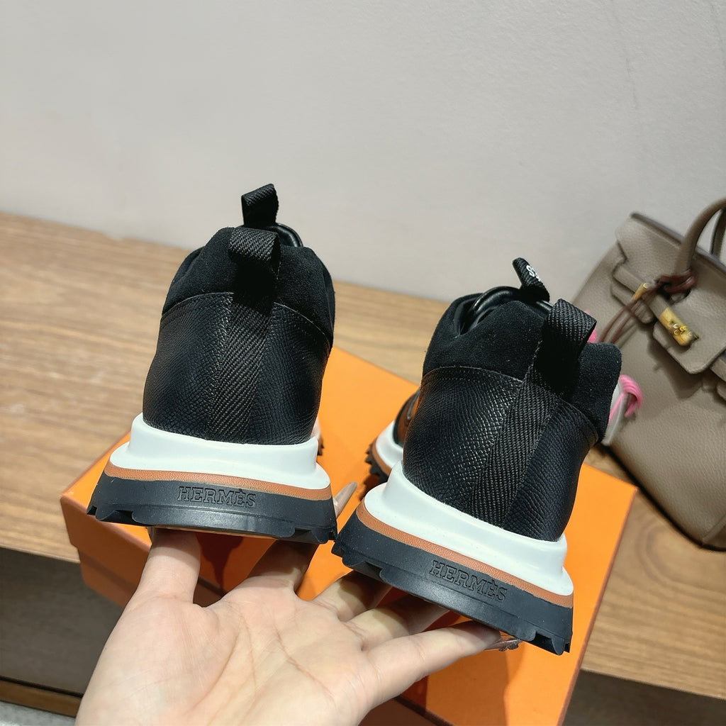 Hermes unisex sneakers in black, visible heel with blue sole trim and white platform