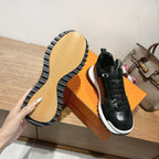 Hermes unisex sneakers with black uppers and patterned rubber outsole, white sole