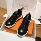 Hermes unisex sneakers in black with laces, shown in orange-and-white shoe box